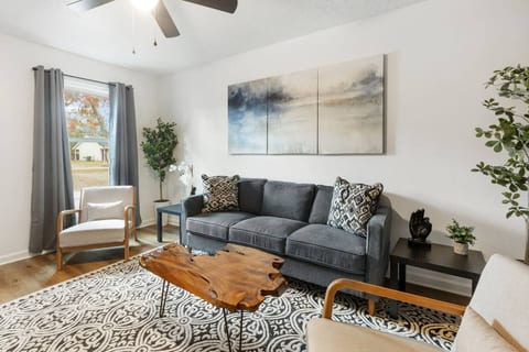 Bright, stylish living room with cozy seating and a statement wood coffee table