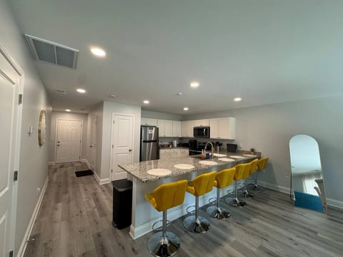 Modern open kitchen with granite island and seating for five