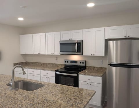 Bright modern kitchen with granite counters and stainless appliances