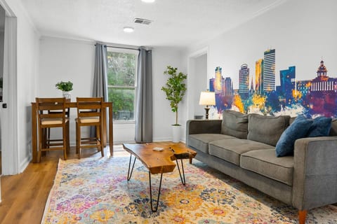 Bright, stylish lounge with skyline mural and cozy dining nook