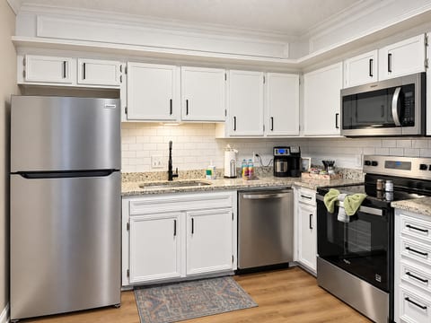 Bright updated kitchen with granite counters and stainless appliances