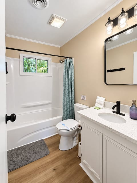 Bright updated bathroom with tub-shower combo and modern vanity