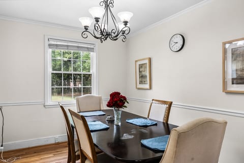 Bright formal dining room with seating for 6 and garden-view window
