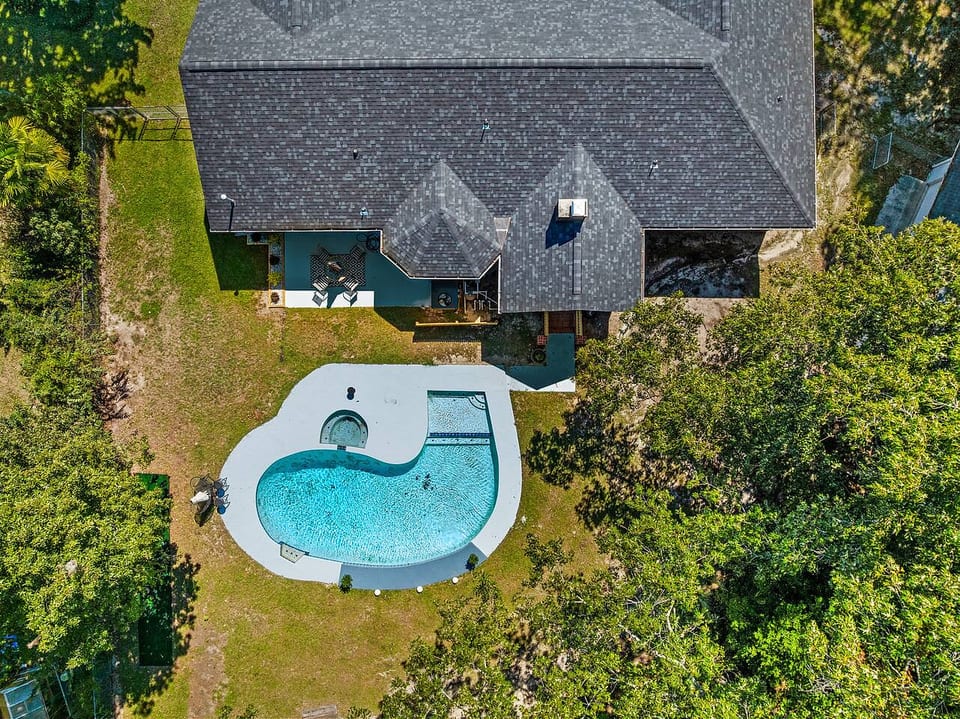Private backyard oasis with resort-style pool, spa, and shaded patio