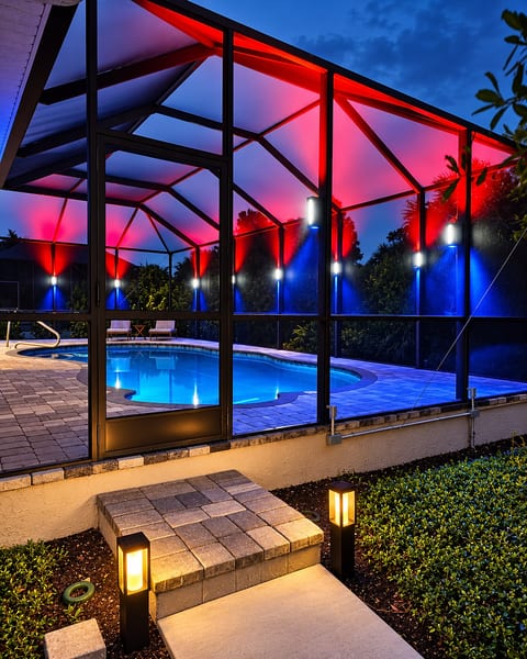 Resort-style screened pool with stunning evening LED lighting