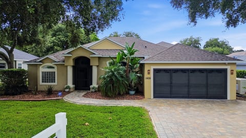 Charming single-story home with tropical landscaping and great curb appeal