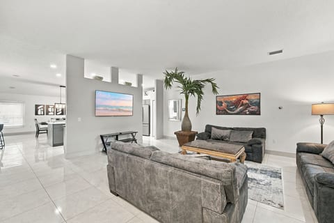 Bright open-concept living room with modern seating and easy kitchen flow