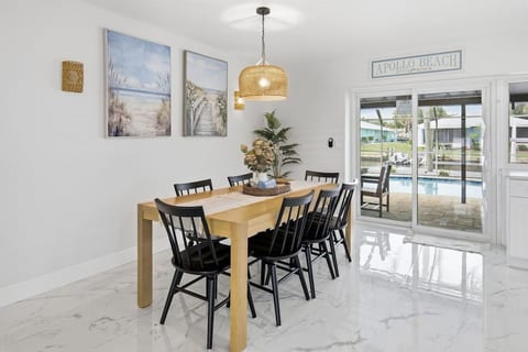Gather around the dining table just off the kitchen, perfect for family meals, morning coffee, or planning the day together.