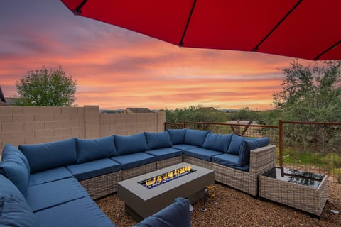 Sunset patio with fire table, plush sectional, and relaxing outdoor vibes