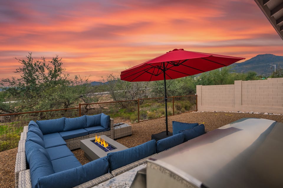Sunset patio with fire pit, grill, and mountain-view lounge seating