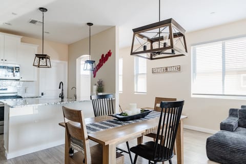Bright farmhouse-style dining area with open kitchen and natural light