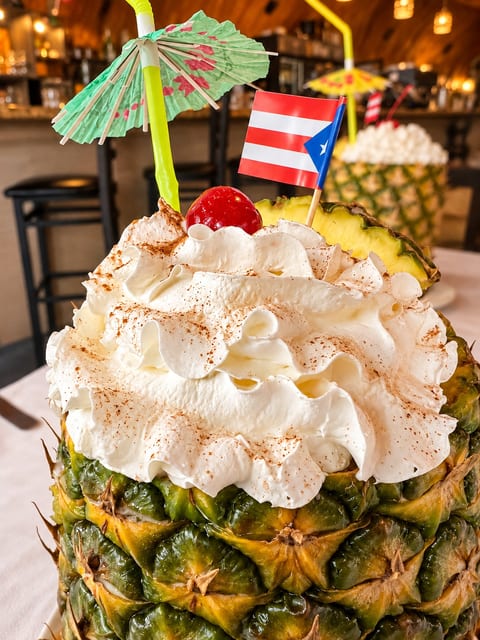 Tropical pineapple cocktail with festive flair in a warm island-style bar