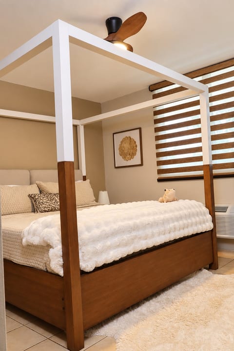 Soft bedding, warm wood, and a canopy bed create a restful retreat after exploring Rincón.
