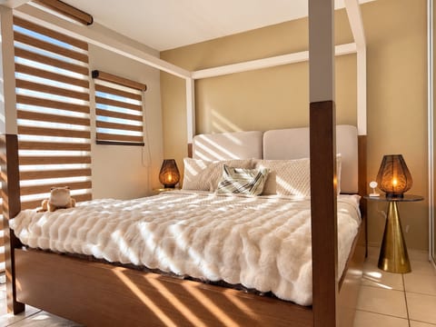 Soft bedding, warm wood, and a canopy bed create a restful retreat after exploring Rincón.