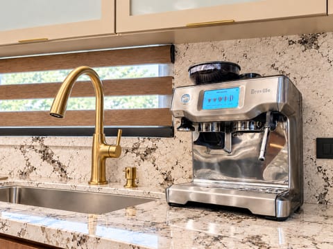 Premium espresso station with elegant gold fixtures and bright modern finishes