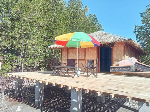 Tables, chairs and beach umbrella on an spacious deck. Where you can relax and sip your favourite drinks.