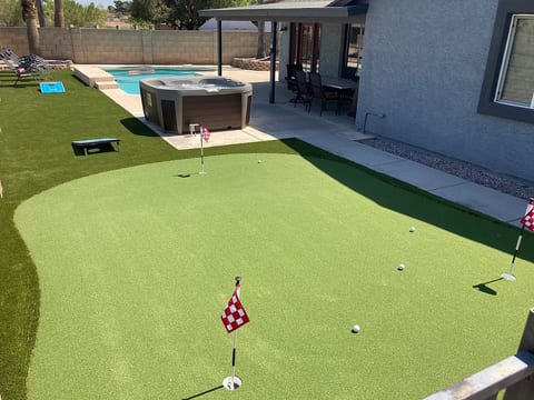 Large entertaining backyard with putting green, hot tub, pool and shade.