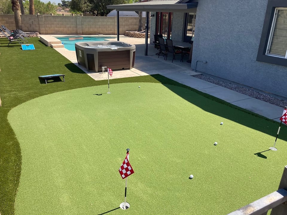 Large entertaining backyard with putting green, hot tub, pool and shade.
