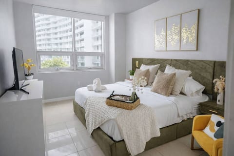 King bed with natural light and tv