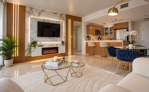 Stylish open living space with fireplace, modern kitchen, and chic dining