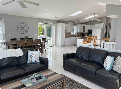Open concept living, dining, and kitchen - perfect for groups! Beautiful natural light from windows and skylights. Large screen TV. Deck access.
