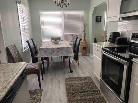 Kitchen with 6 seat dining table . Stainless steel full fridge, microwave , glass top oven , Airfryer, Keurig coffee maker , toaster, deep sink , dishwasher, fully equipped with plates, silverware, bowls, kitchen essentials , cooking ware