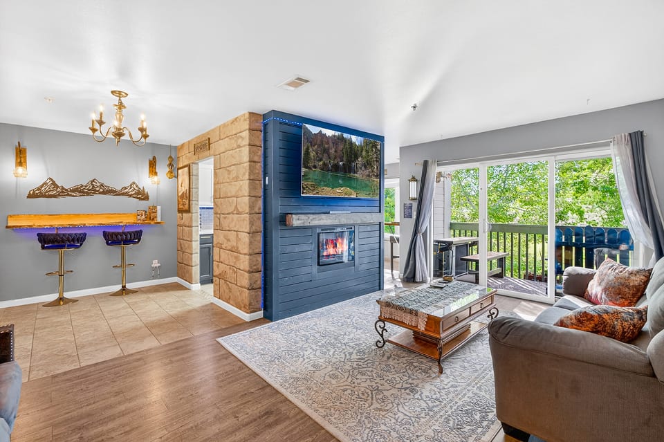 Cozy fireplace lounge with forest-view deck and stylish breakfast bar