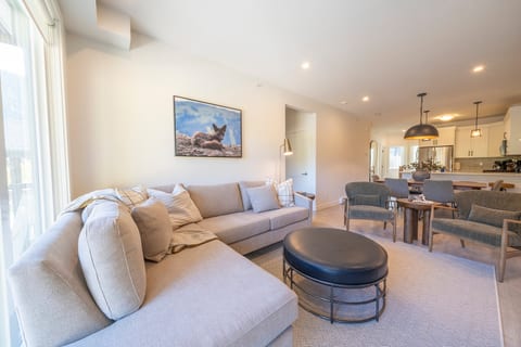 Clean alpine aesthetic meets cozy relaxation. Soft neutral textures, Sun Peaks local photography, and generous seating provide the perfect gathering spot for the entire family.