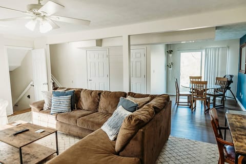 One of two living spaces in the home.  This one boasts a 65" Smart TV with Bluetooth Soundbar, desk/work area, and small dining nook for dining overflow seating for larger groups.  