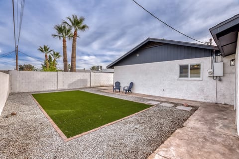 Private fenced backyard with turf lawn and easy outdoor seating