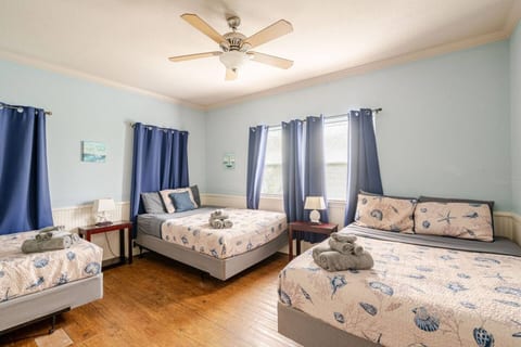 Bedroom with three queen beds, room for the whole crew