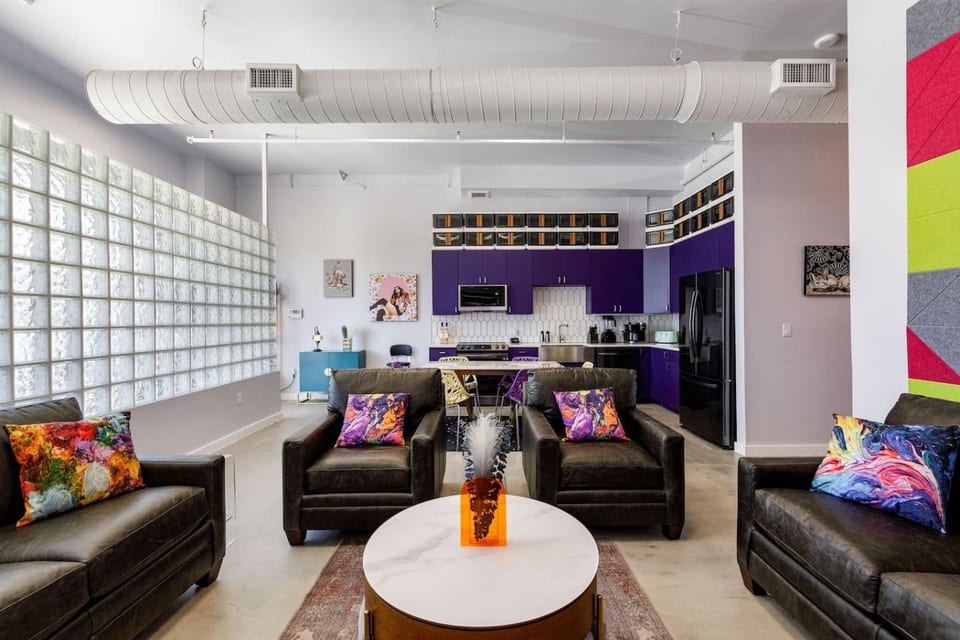 Loft-style great room with glass block walls and leather seating
