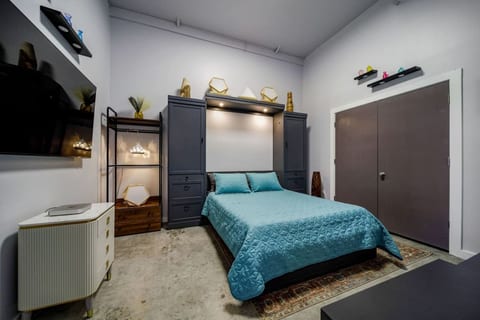 Bedroom with a Murphy bed and smart TV