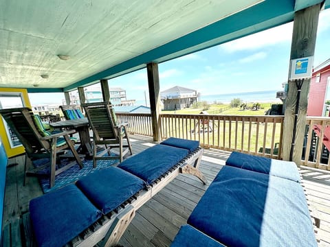 Covered deck with loungers and wide Gulf views