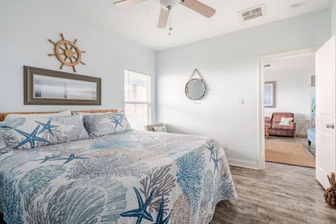 Primary bedroom with a king bed and plenty of natural light