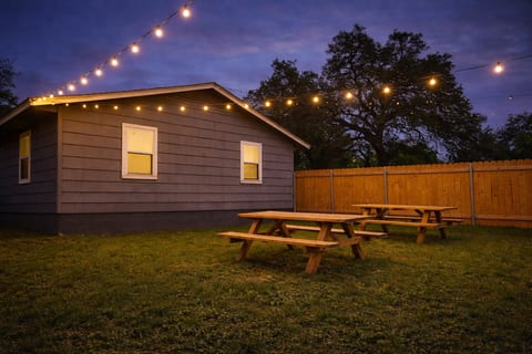 Picnic tables under the lights at dusk