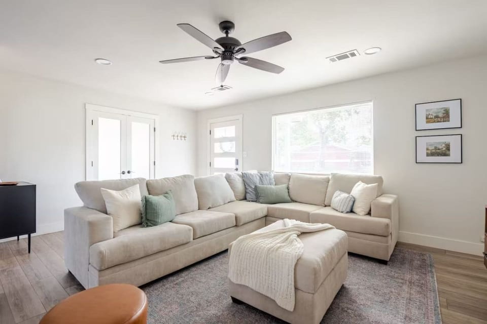 Bright living room with a big sectional and ottoman