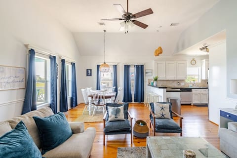Bright main living room with pine floors and plenty of seating