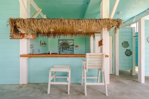 Thatched tiki bar under the house