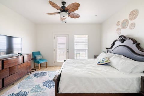 Primary bedroom with a king bed and a private deck door