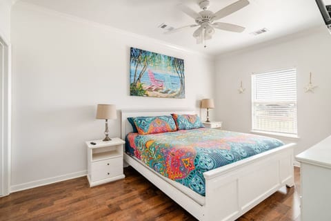 Queen bedroom with bright tropical bedding