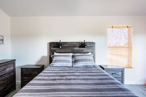 Queen bedroom with soft striped bedding