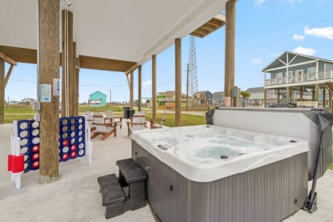 Bubbling hot tub under the house, with games and seating close by