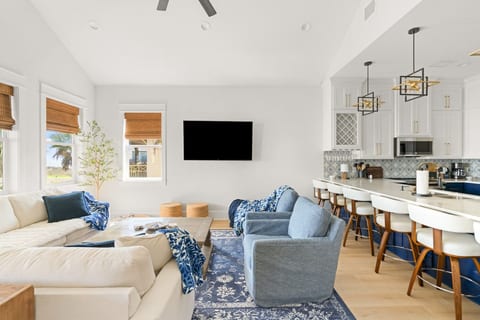 Bright open living room with a big sectional and kitchen bar
