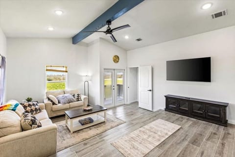 Living room with vaulted ceilings and a big smart TV
