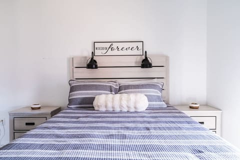 Queen bedroom with soft striped bedding
