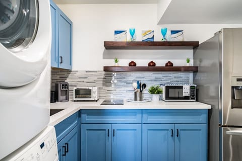 Kitchen with blue cabinets and stainless appliances