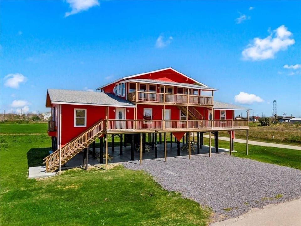 Bright red beach triplex with long covered decks