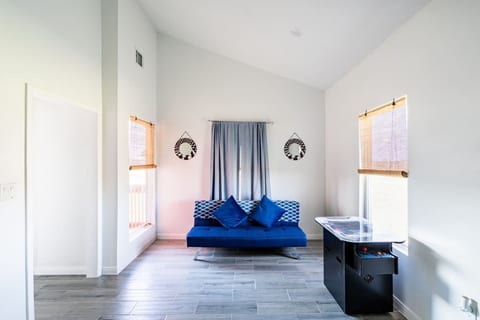 Lounge area with a futon and an arcade table