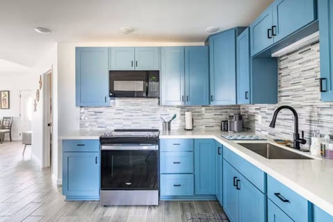 Kitchen with blue cabinets and quartz counters